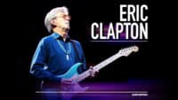 Plakat promujący trasę Erica Claptona z wizerunkiem muzyka z gitarą. Na samym dole w rogu logo Live Nation.